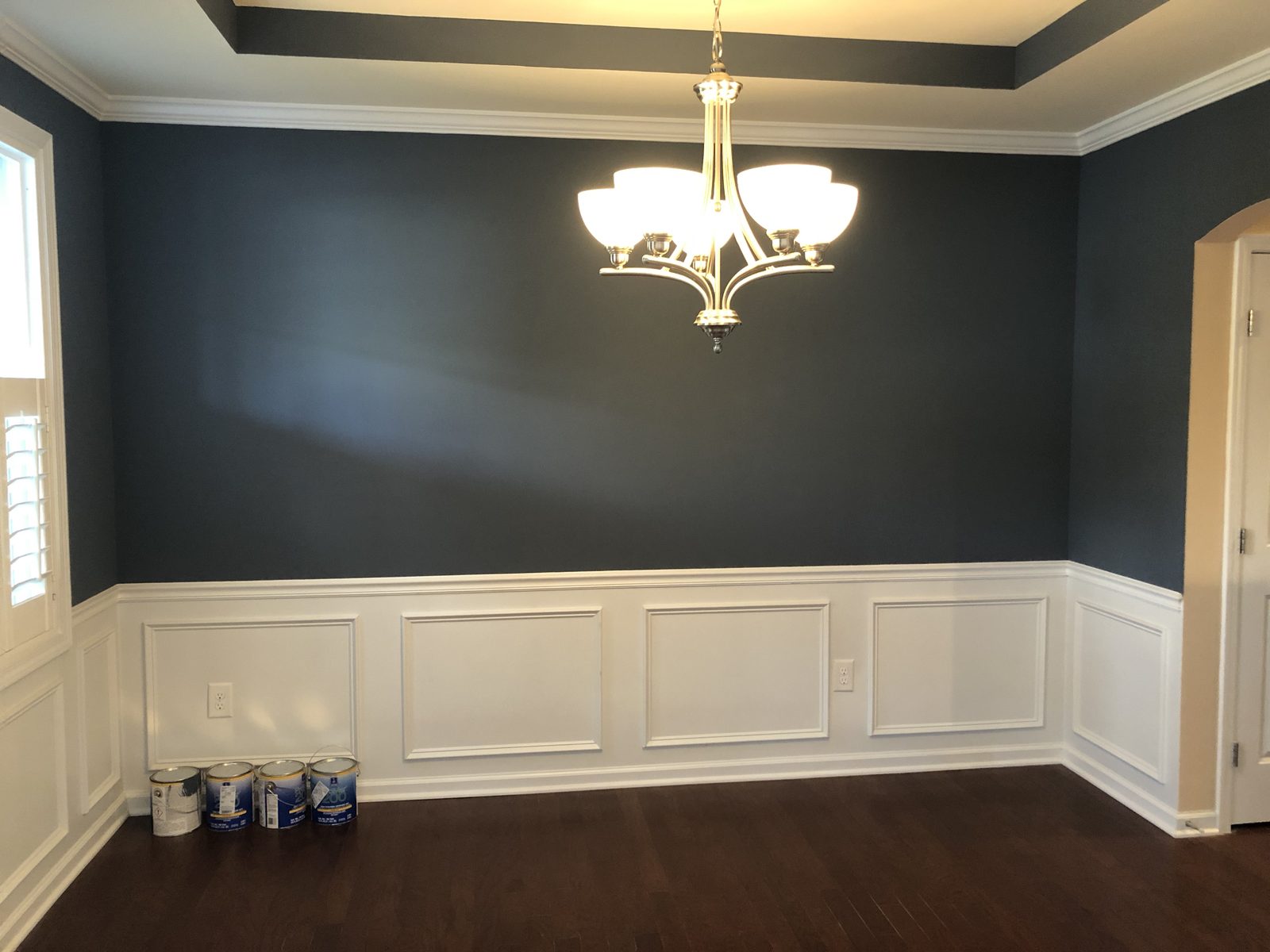 Dining room painted deep navy above white wainscoting in a Mebane, NC home — interior painting by Roca’s Painters of Mebane, NC