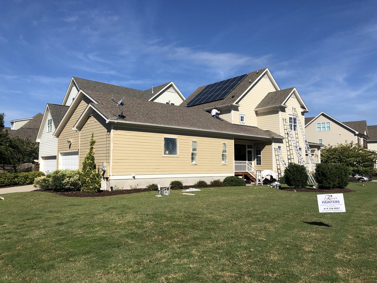 Two-story home in Cary, NC after siding and trim painting — exterior painting by Roca’s Painters of Mebane, NC