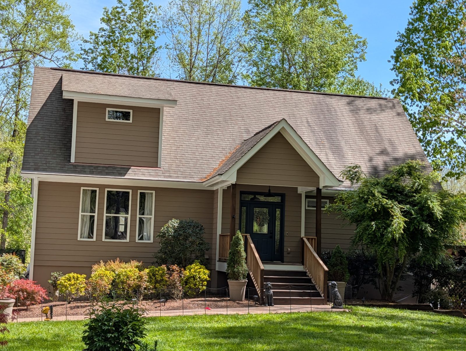 Tan craftsman home with painted trim and shutters — exterior painting by Roca’s Painters of Mebane, NC