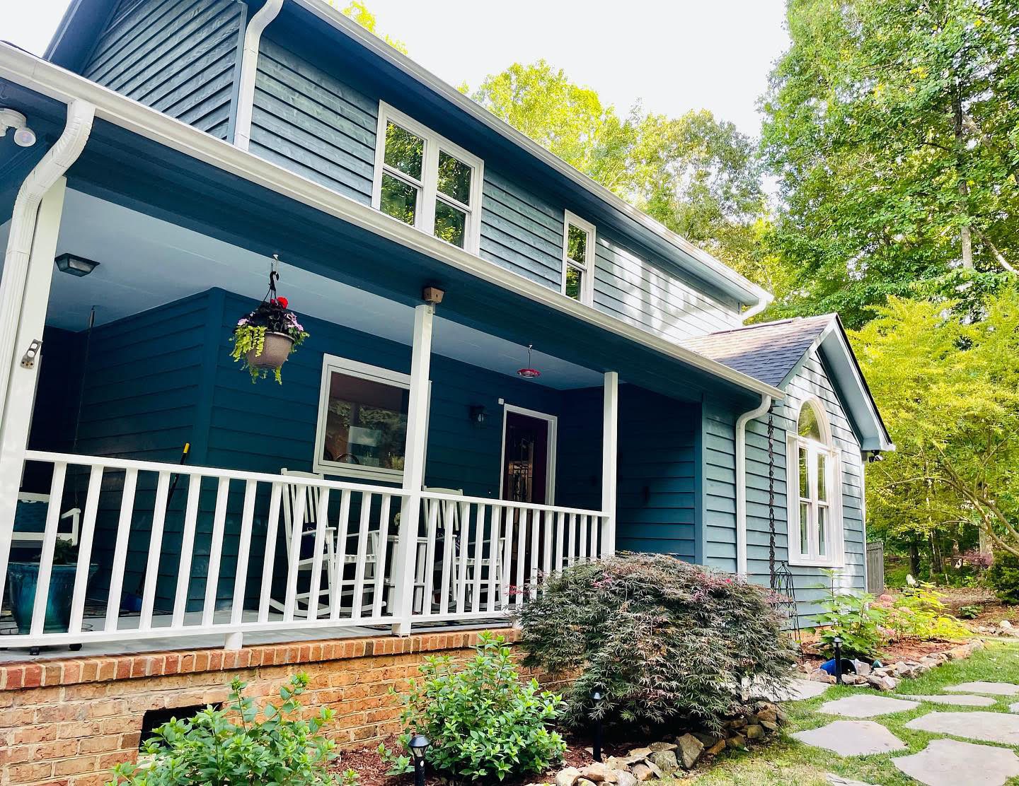 Blue siding and white porch railings after exterior painting — exterior painting by Roca’s Painters of Mebane, NC
