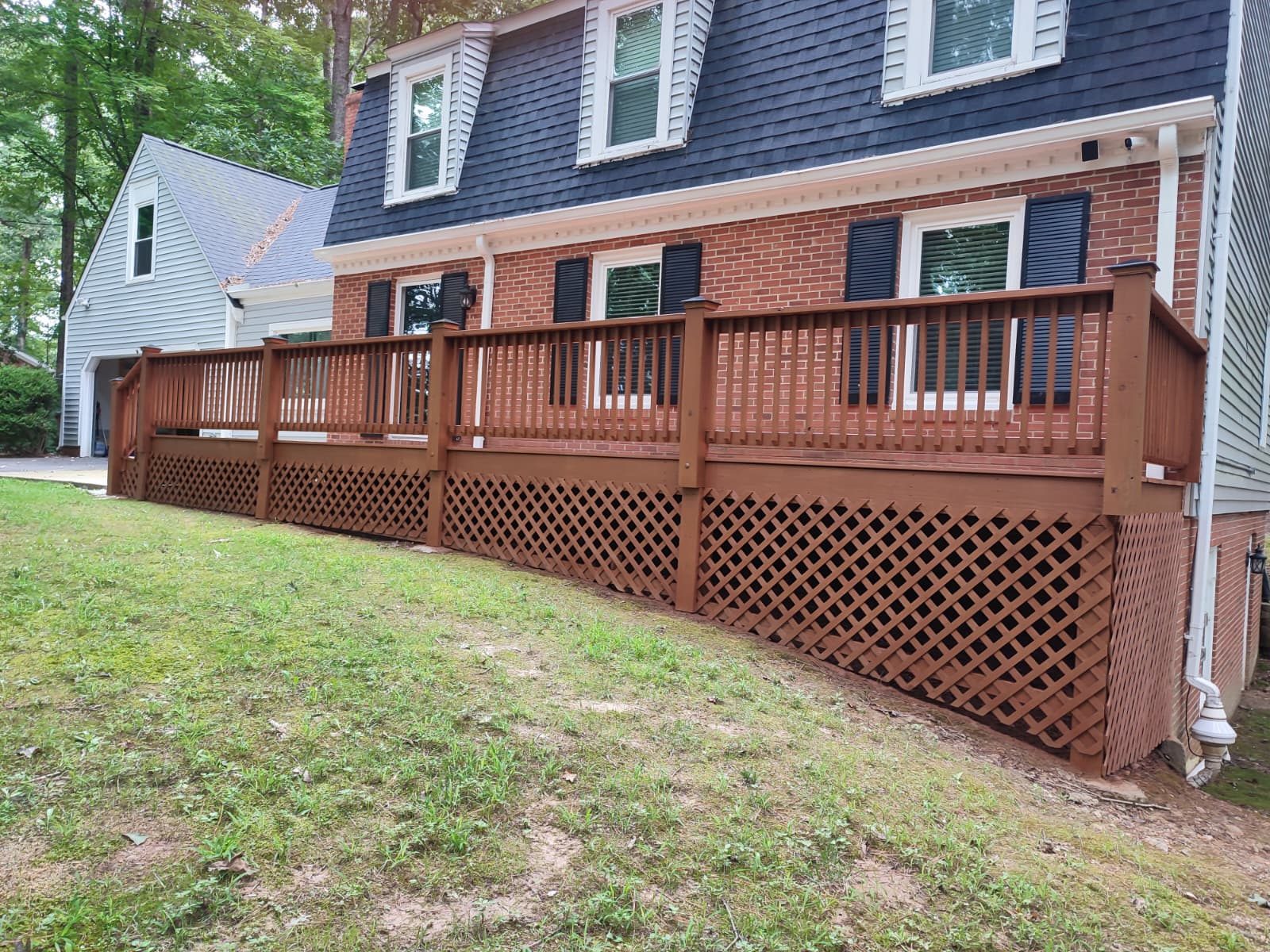 Deck boards and railing re-stained after pressure washing — exterior painting by Roca’s Painters of Mebane, NC