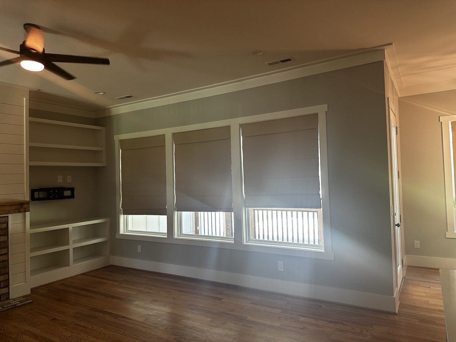 Living room with painted built-in shelving and soft green walls after an interior repaint — interior painting by Roca’s Painters of Mebane, NC