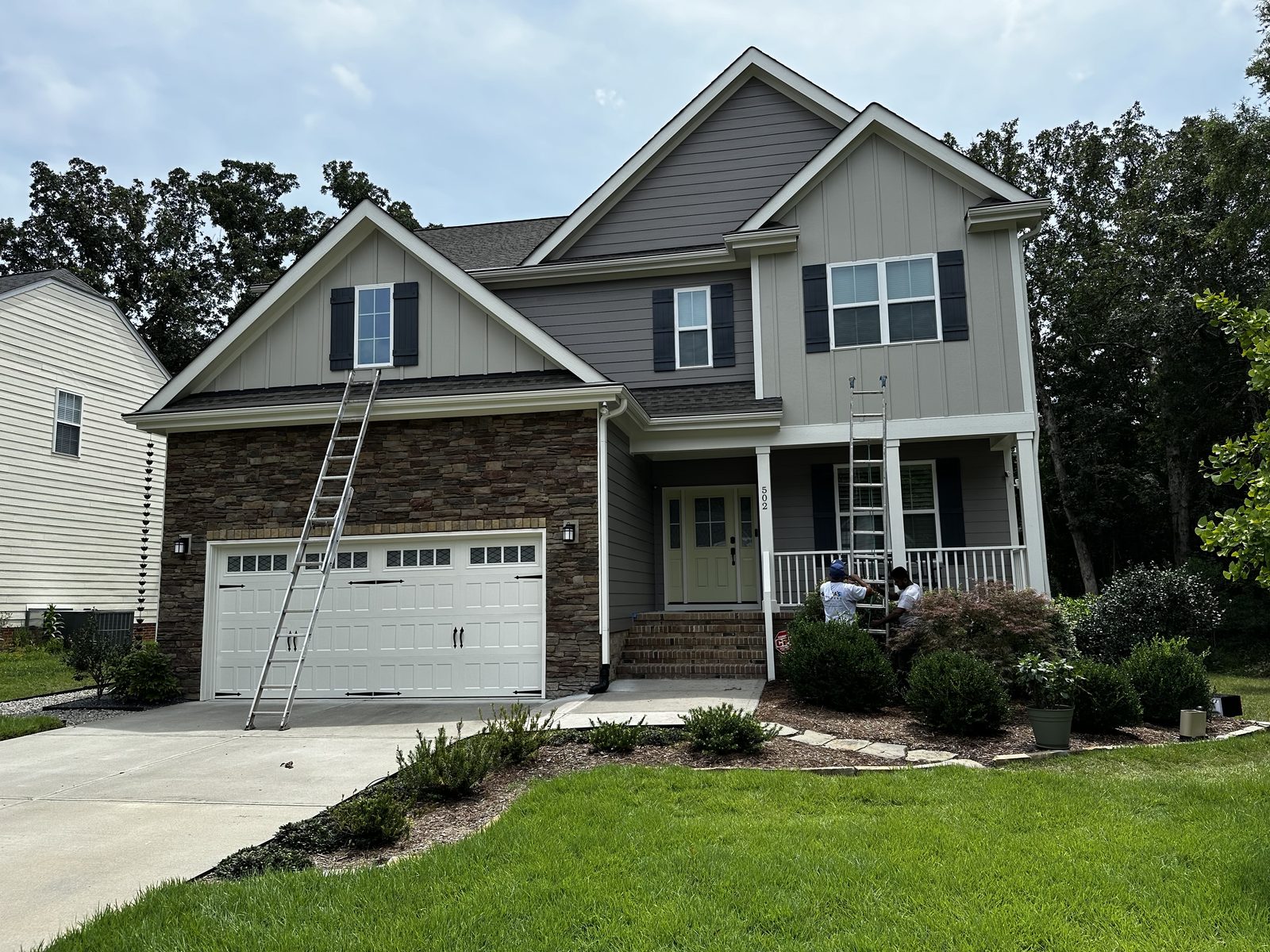 Gray siding with fresh white trim after an exterior repaint — exterior painting by Roca’s Painters of Mebane, NC