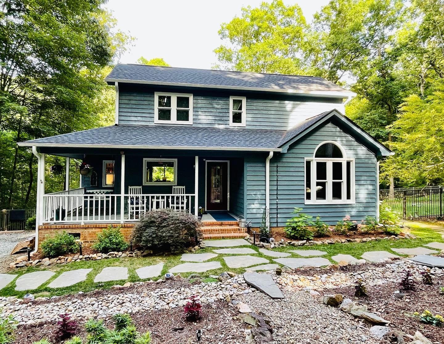 Blue craftsman home with painted porch columns and front door — exterior painting by Roca’s Painters of Mebane, NC